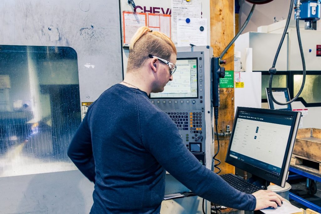 Machinist working with a stand-alone machine tool